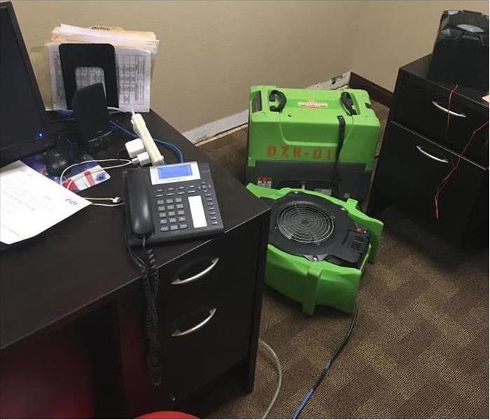 SERVPRO water equipment on the floor in a office 