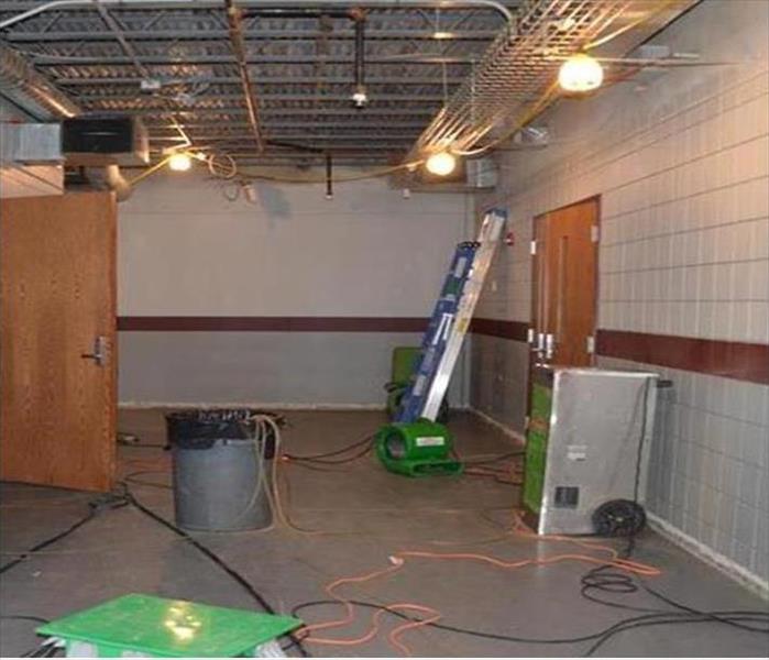 SERVPRO water damage equipment on a gym floor