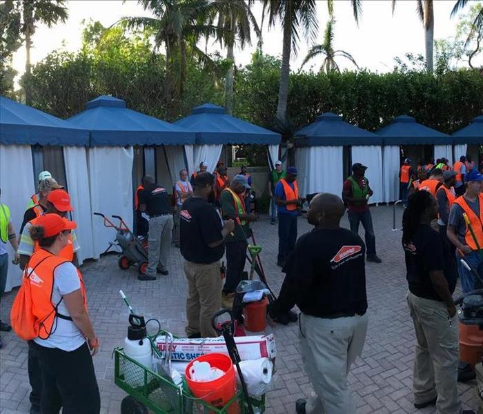 SERVPRO storm damage team standing in a area with bungalows 